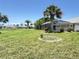 This home features a spacious backyard with lush green grass and plenty of room to roam at 1438 Razorbill Ln, Punta Gorda, FL 33983