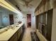 Bathroom with bathtub-shower, single vanity, overhead lighting, and access to bedroom at 1438 Razorbill Ln, Punta Gorda, FL 33983