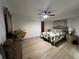 Bedroom with a queen bed, ceiling fan, laminate flooring, and lamps at 1438 Razorbill Ln, Punta Gorda, FL 33983