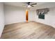 This large bedroom with wood-look flooring offers a bright, comfortable space with a ceiling fan at 1438 Razorbill Ln, Punta Gorda, FL 33983