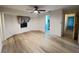 Bright bedroom with laminate flooring, ceiling fan, and access to an en-suite bathroom at 1438 Razorbill Ln, Punta Gorda, FL 33983
