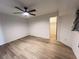 Spacious bedroom featuring hardwood floors, a modern ceiling fan, and a walk-in closet at 1438 Razorbill Ln, Punta Gorda, FL 33983