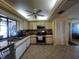 Bright kitchen with stainless steel appliances, ample cabinets, and a breakfast bar area at 1438 Razorbill Ln, Punta Gorda, FL 33983