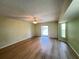 Empty living room featuring laminate floors, sliding door access, and neutral color scheme at 1438 Razorbill Ln, Punta Gorda, FL 33983