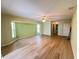 Inviting living room with new hardwood floors, a ceiling fan, and large windows providing ample natural light at 1438 Razorbill Ln, Punta Gorda, FL 33983