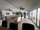 Bright living room with tile floors, large sectional, and expansive sliding glass doors to the patio at 1438 Razorbill Ln, Punta Gorda, FL 33983