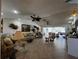 Spacious living room featuring tile floors, ceiling fans, and sliding glass doors to an outdoor patio at 1438 Razorbill Ln, Punta Gorda, FL 33983