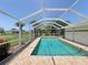 Enjoy the beautiful pool area, perfect for relaxation and entertaining in the screened-in lanai at 1438 Razorbill Ln, Punta Gorda, FL 33983