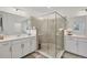 Bathroom with a walk-in shower, double vanity, and white cabinets at 14672 Sycamore Ct # 3622, Punta Gorda, FL 33955