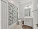 Small bathroom with shower/tub combo, white vanity, and patterned shower curtain at 14672 Sycamore Ct # 3622, Punta Gorda, FL 33955