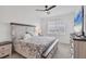 Main bedroom with king-size bed, large window, and ceiling fan at 14672 Sycamore Ct # 3622, Punta Gorda, FL 33955