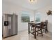 Cozy breakfast nook with a wooden table and four chairs near a window at 14672 Sycamore Ct # 3622, Punta Gorda, FL 33955