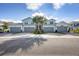 Front view of three-unit building with grey garage doors at 14672 Sycamore Ct # 3622, Punta Gorda, FL 33955