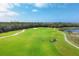 Golf course with players, golf carts, and water features at 14672 Sycamore Ct # 3622, Punta Gorda, FL 33955