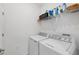Laundry room with washer, dryer, and shelving for storage at 14672 Sycamore Ct # 3622, Punta Gorda, FL 33955