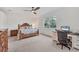 Spacious main bedroom with a king-size bed and an adjacent workspace at 14672 Sycamore Ct # 3622, Punta Gorda, FL 33955