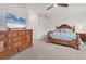 Bright bedroom with a king bed and wood dresser, TV included at 14672 Sycamore Ct # 3622, Punta Gorda, FL 33955