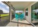Screened porch with turquoise furniture and view of the golf course at 14672 Sycamore Ct # 3622, Punta Gorda, FL 33955