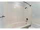 Bathroom with soaking tub, tiled walls, and modern fixtures at 1600 W Marion Ave # 234, Punta Gorda, FL 33950