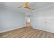 Empty bedroom with wood-look floors, ceiling fan, and open door to adjacent room at 1600 W Marion Ave # 234, Punta Gorda, FL 33950