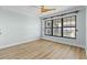 Bright bedroom with wood-look flooring, ceiling fan, and large window at 1600 W Marion Ave # 234, Punta Gorda, FL 33950