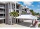 Exterior view of a modern gray and white condo building with covered parking at 1600 W Marion Ave # 234, Punta Gorda, FL 33950