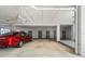 Covered parking space with a red car and storage units at 1600 W Marion Ave # 234, Punta Gorda, FL 33950