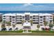 Front exterior view of a multi-story condominium building with parking and landscaping at 1600 W Marion Ave # 234, Punta Gorda, FL 33950
