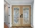 Interior view of double entry doors with decorative glass and adjacent hallway at 1600 W Marion Ave # 234, Punta Gorda, FL 33950