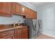 Laundry room with washer, dryer, sink, and ample cabinet space at 1600 W Marion Ave # 234, Punta Gorda, FL 33950