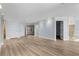Open-concept living room with wood-look floors, light blue walls, and recessed lighting at 1600 W Marion Ave # 234, Punta Gorda, FL 33950