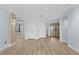 Spacious living room with wood-look flooring, light blue walls, and multiple entryways at 1600 W Marion Ave # 234, Punta Gorda, FL 33950