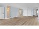 Spacious living area with wood floors, light blue walls, and view of the adjacent kitchen at 1600 W Marion Ave # 234, Punta Gorda, FL 33950
