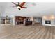 Open-concept living area with wood floors, fireplace, and kitchen at 1600 W Marion Ave # 234, Punta Gorda, FL 33950