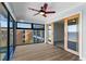 Inviting sunroom with wood floors and sliding doors leading to the waterfront view at 1600 W Marion Ave # 234, Punta Gorda, FL 33950
