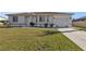 House exterior showcasing a single-story home with a driveway and lawn at 18107 Bracken Cir, Port Charlotte, FL 33948