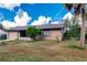 Side view of a single story house with a garage and landscaped lawn at 18456 Yarbrough Ave, Port Charlotte, FL 33948