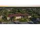 Aerial view of condo building at dusk, surrounded by trees at 19505 Quesada Ave # M205, Port Charlotte, FL 33948