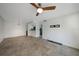 Living and dining room with tile floors, ceiling fan and view to kitchen at 19505 Quesada Ave # M205, Port Charlotte, FL 33948