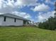 Backyard of the house showing a deck with a grassy area at 200 Dolphin Pkwy, Punta Gorda, FL 33950