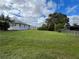 Spacious, fenced backyard with palm trees and green grass at 200 Dolphin Pkwy, Punta Gorda, FL 33950