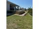 Inviting backyard deck with steps down to the yard, perfect for outdoor relaxation and entertaining at 200 Dolphin Pkwy, Punta Gorda, FL 33950
