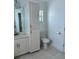 Bathroom featuring a single sink, built-in cabinets, a toilet and tile flooring at 200 Dolphin Pkwy, Punta Gorda, FL 33950