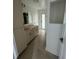 Bathroom featuring white cabinetry, a tiled floor, and an alcove at 200 Dolphin Pkwy, Punta Gorda, FL 33950