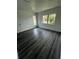 Bright bedroom with lots of natural light and dark wood-like floors at 200 Dolphin Pkwy, Punta Gorda, FL 33950