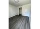 Spacious bedroom with walk-in closet and dark wood-like floors at 200 Dolphin Pkwy, Punta Gorda, FL 33950