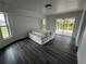 Bedroom with sliding glass door, dark floors, and white walls at 200 Dolphin Pkwy, Punta Gorda, FL 33950