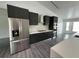 Modern kitchen with dark gray cabinets, stainless steel appliances and white countertops at 200 Dolphin Pkwy, Punta Gorda, FL 33950