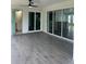 An inviting covered patio with tile flooring, fan, and views into the house and bathroom at 200 Dolphin Pkwy, Punta Gorda, FL 33950