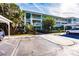 Building exterior with parking spaces and lush landscaping under a clear blue sky at 2020 Willow Hammock Cir # 105, Punta Gorda, FL 33983